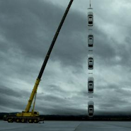 Five Lexus vehicles suspended by a crane