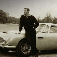 Sean Connery leaning against Aston Martin DB5