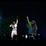 Janelle Monae performing in Los Angeles alongside a hologram of M.I.A. performing in New York