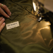 Final touches on Purdey fieldcoat 