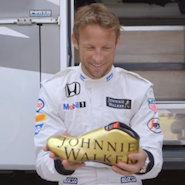 Jenson holds a pair of McLaren's golden boots
