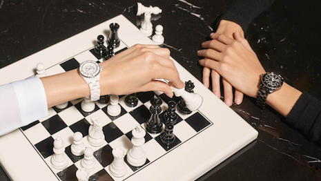Promotional image for Chanel's J12 timepieces in white and black 