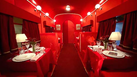 Cocktail train carriage by Christian Louboutin in the lobby of London's Claridge's hotel for Christmas 2019. Image credit: Claridge's