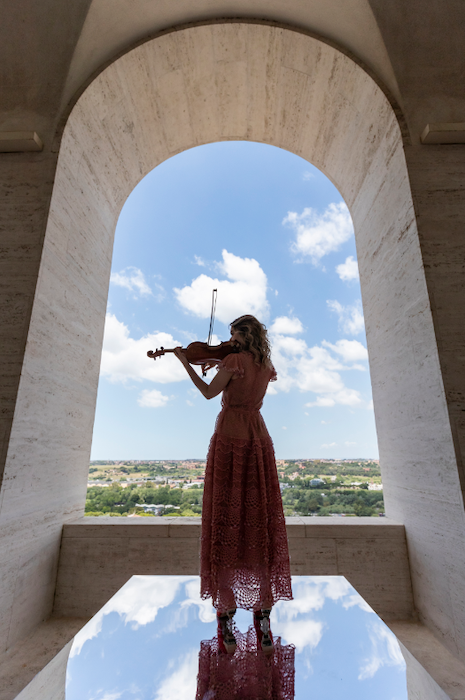 Summer Solstice performance of Antonio Vivaldi’s Estate from The Four Seasons executed by the orchestra of the Accademia Nazionale di Santa Cecilia and star violinist Anna Tifu, dressed in Fendi looks. Image courtesy of Fendi