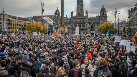 People are seen gathered on George Square during a rally Nov. 5, 2021 in Glasgow, Scotland. Day Six of the 2021 climate summit in Glasgow focused on youth and public empowerment. Outside the COP26 site, on the streets of Glasgow, the "Fridays For Future" youth climate movement held a march to George Square in the center of Glasgow where popular youth activists addressed the crowd. The 26th "Conference of the Parties" represented a gathering of all the countries signed on to the U.N. Framework Convention on Climate Change and the Paris Climate Agreement. The aim of this year's conference was to commit countries to net-zero carbon emissions by 2050. Image by Peter Summers/Getty Images