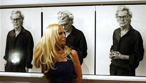 Donatella stands in front of a portrait of Richard Avedon