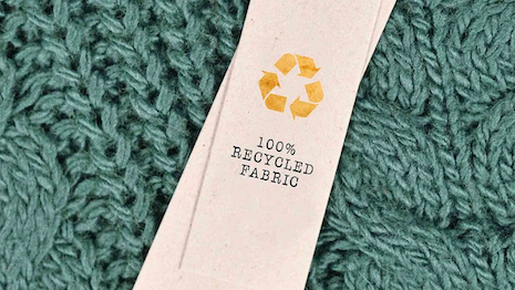 Photo of 100pc recycled fabric tag from Bain & Co. report