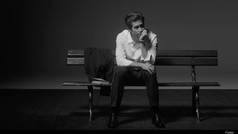 The actor sits on a bench in one of the campaign's 12 chapters. Image credit: Cartier