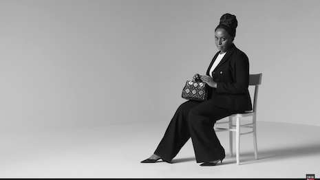 Ms. Adichie poses with 95.22, the latest edition of the Lady Dior bag. Image credit: Dior